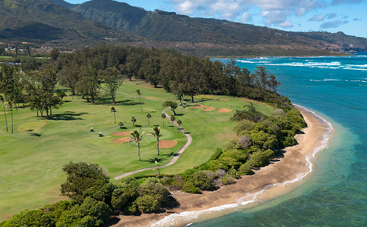 Coastline against golf course
